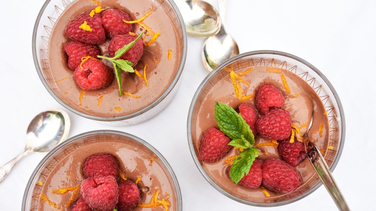 Low carb chocolate pudding with raspberries and orange zest