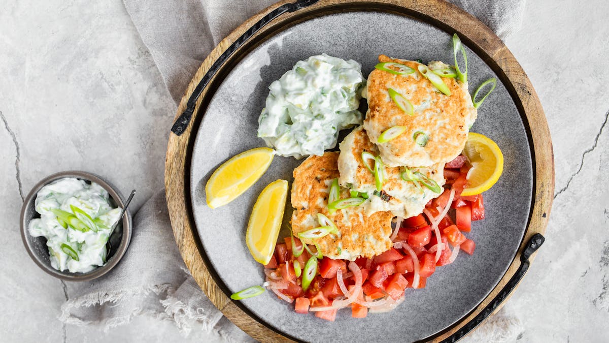 Keto chicken fritters with avocado tzatziki and tomato salad
